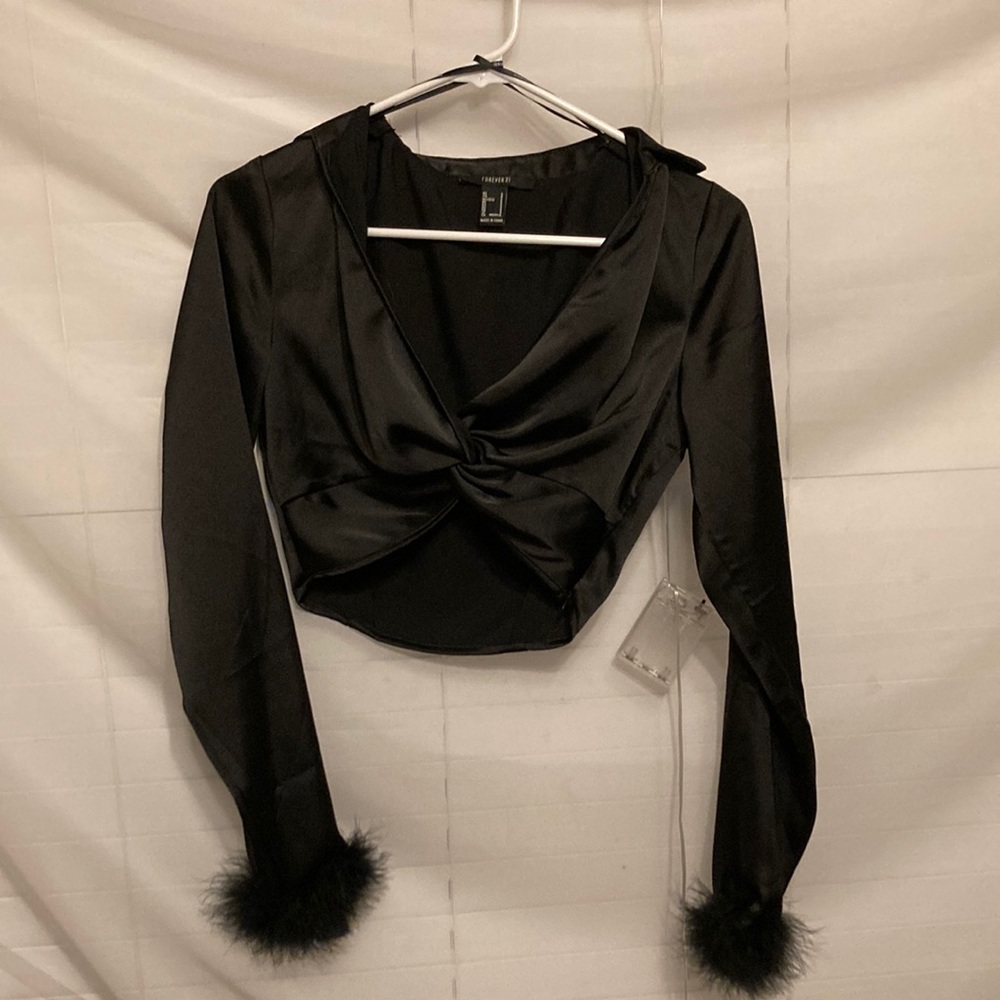 Silk material and black feathers on the bottom of the sleeves, worn once.